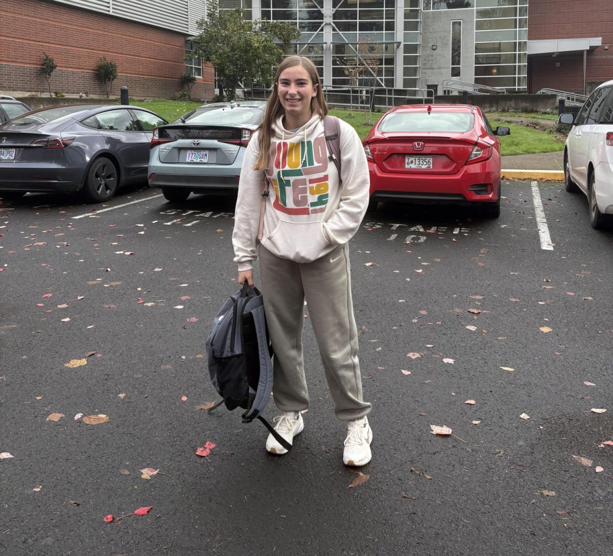 Photo of Mia Rucker, sophomore outside of the point at Wilsonville High School. Mia is carrying in her many backpacks after going out to lunch.