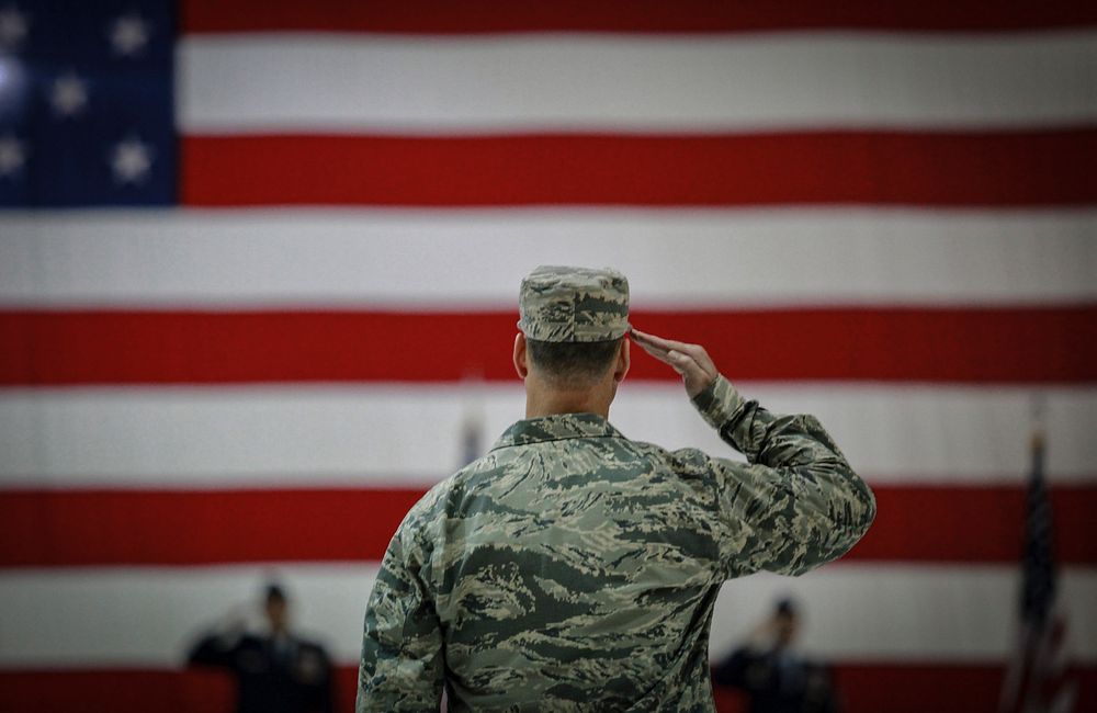 U.S. airmen salutes during an assumption of command ceremony. Original public domain image from Flickr.