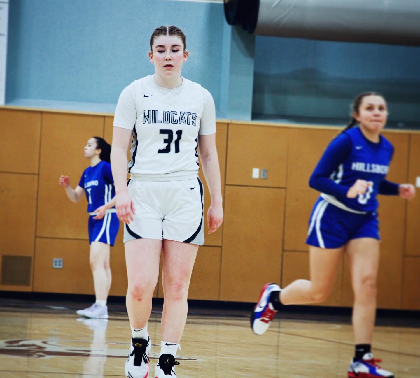 Starting varsity point guard for the Wilsonville Wildcats, Gabi Moultrie, heads up court towards her defensive position. Leading her team in points most games, especially from behind the 3-point line, Moultrie sets the pace for her team and has supported the varsity squad since her freshman season. 