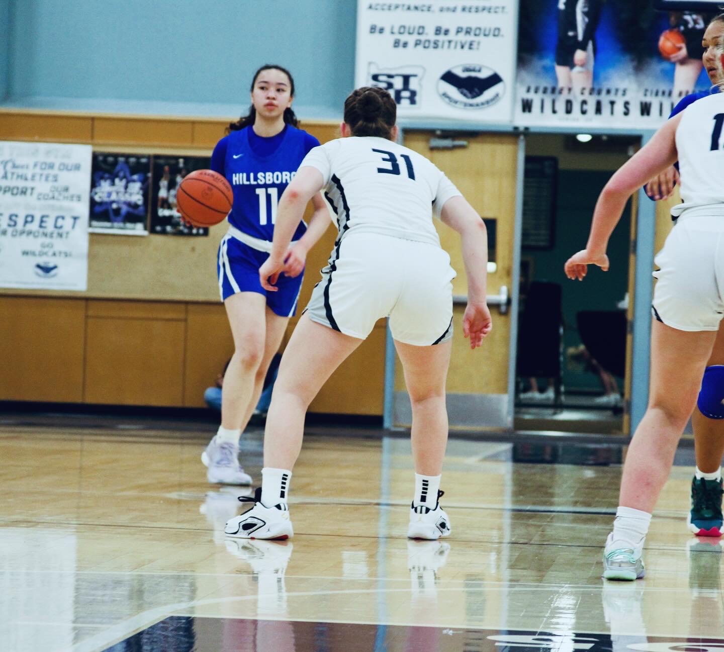 Moultrie, number 31, takes on Hillsboro's point guard as she dribbles down the court. Moutlrie moves quickly with agility and purpose, renowned for her quick hands in stealing the ball and making fast breaks. 