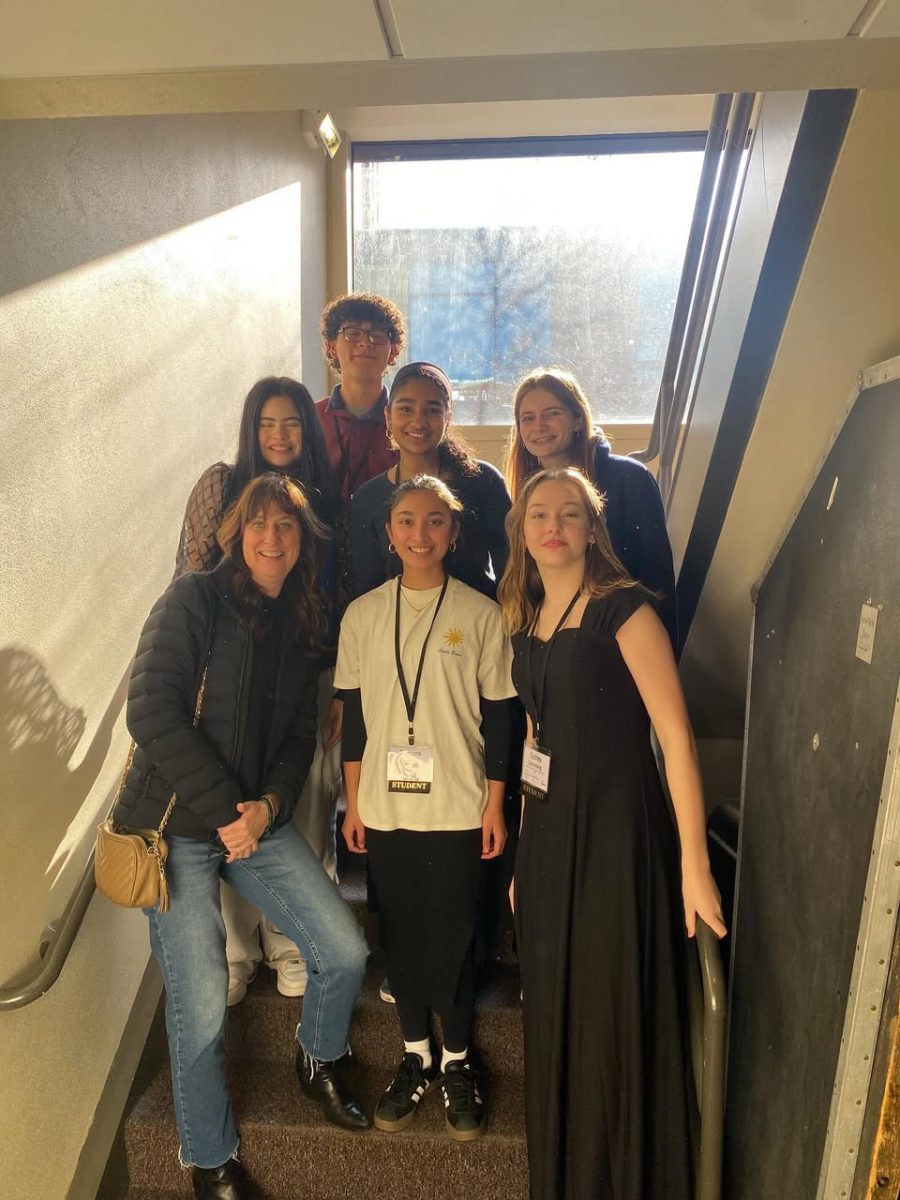 The students of Wilsonville High School pose together at All-State choir. They get ready to perform together after learning new musical techniques from the guest conductors.