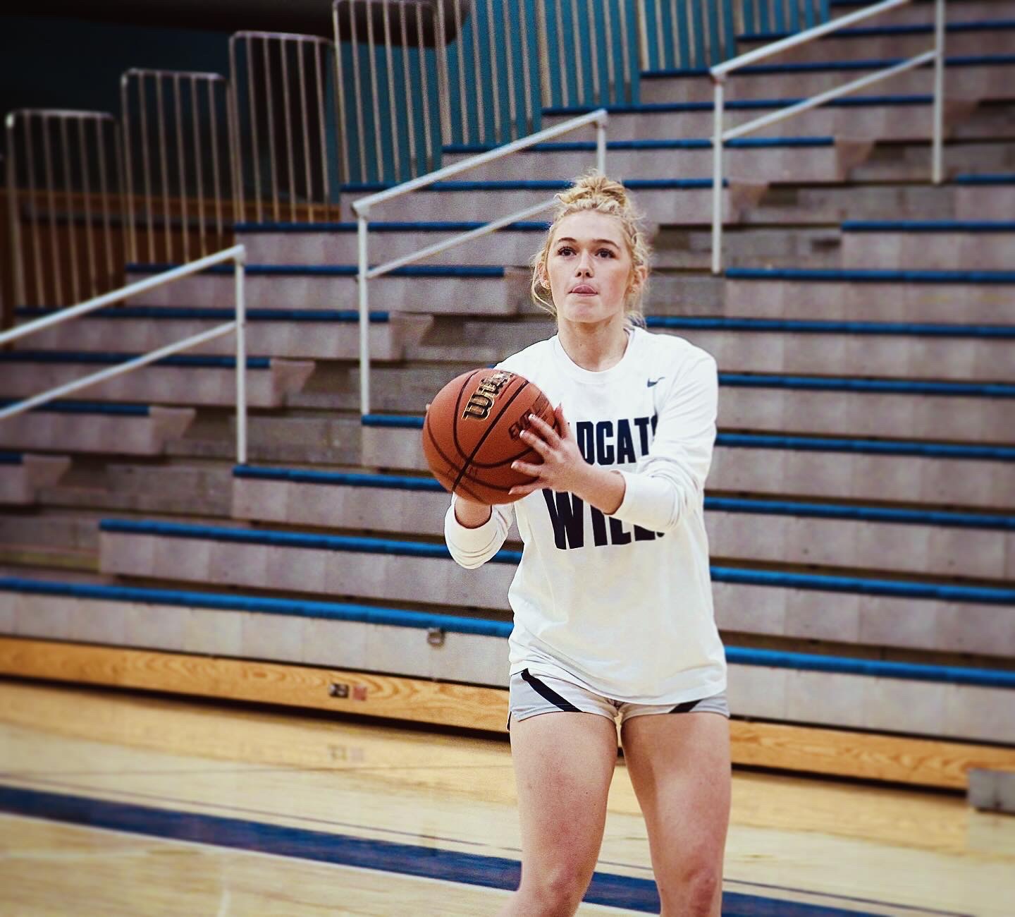 Number 13, Kaia Hix, spends her pre-game time warming up her shot from the perimeter of the three point line. As a junior, Hix has stepped up as a key defender and rebounder for the Wildcats, giving her opponents a run for their money. 