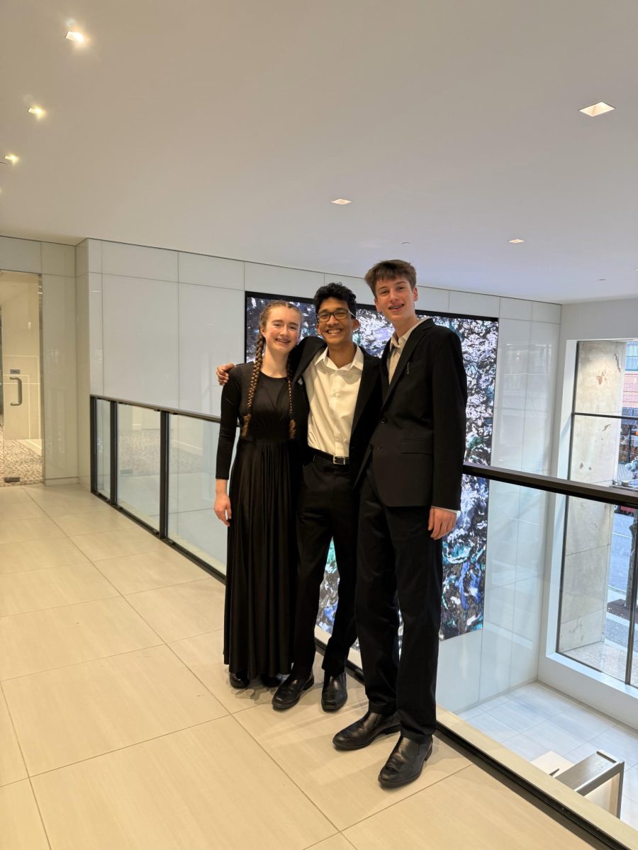 Three students take a photo together at the All Classical Radio station in the KOIN tower after their live radio performance. D'Souza and Brookfield represent Wilsonville High School's music program in the youth chamber group, the Pacific Rose Ensemble. From left to right: Alexandra Brookfield, John D'Souza, Eli Sandgathe. Photo taken by Sophie Ohle.