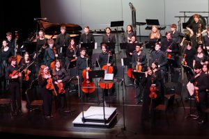 The symphony orchestra rises to their feet after their final piece, marking the end of an action-packed concert. Performing for an audience is a celebration of the work every musical student has pushed themselves toward. 