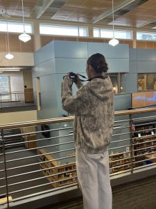 Karli Vannoy photographs Wilsonville's High School library. Vannoy is part of Wilsonville's digital photography class.