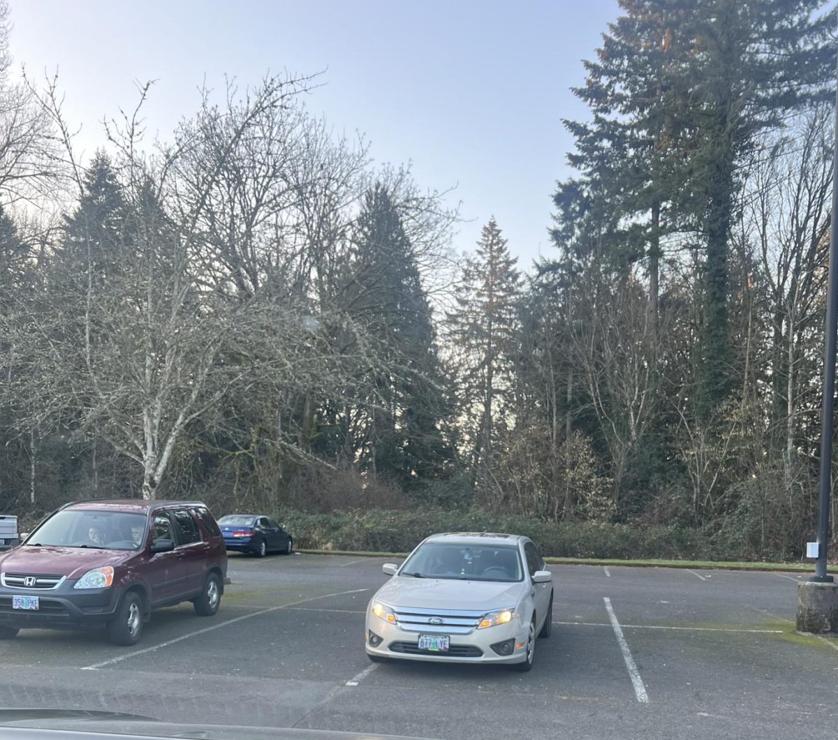 Cars parked in the school parking lot. Why are students forced to pay such a high price for a parking pass, when they can’t even find a good spot?