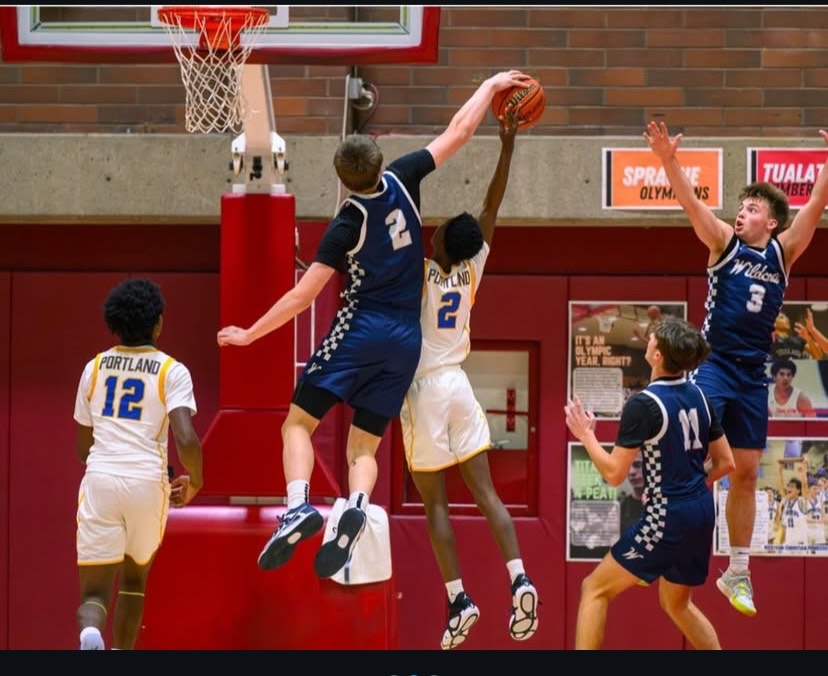 Freshman forward Michael Ratcliffe dominating in the post blocking the layup. Ratcliffe has had a huge presence since arriving in Wilsonville. 