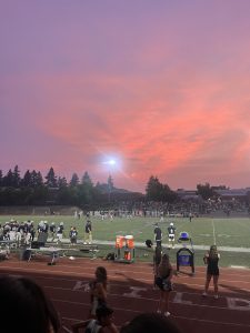 Students showing school spirit at a home football game. Football games are a great way to support school athletics and bring the community together.