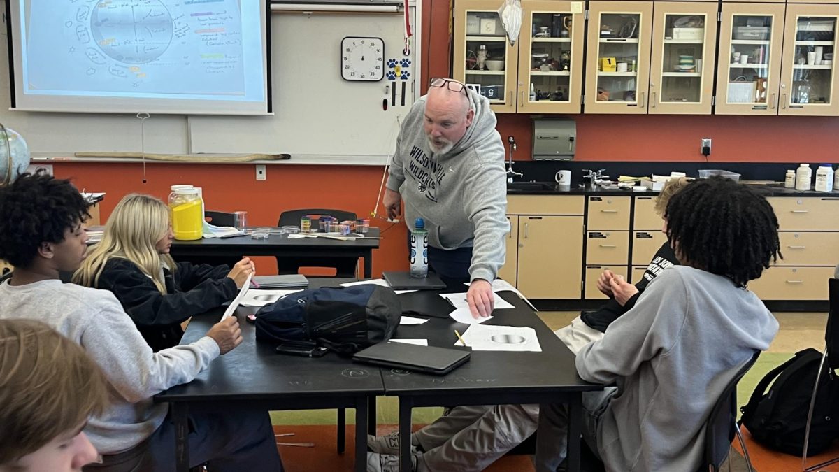 Jason Milham teaches a lesson during his AP Environmental Science class. Students are engaged as he involves himself with them throughout the period. 