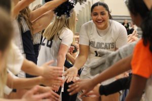 Starter, Fareeda ElManhawy high fiving the youth teams during player announcements. The excitement and thrill from the younger players bring lots of energy to the gym. 