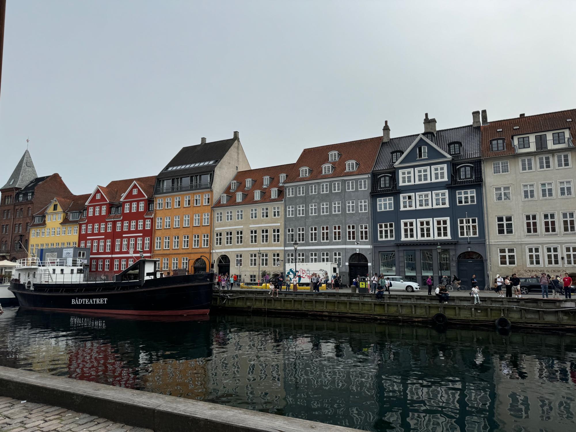 A photo of the world-famous Nyhavn harbor located in Copenhagen, Denmark, known for its colorful houses and boats. Through travel, students get the opportunity to experience new things.