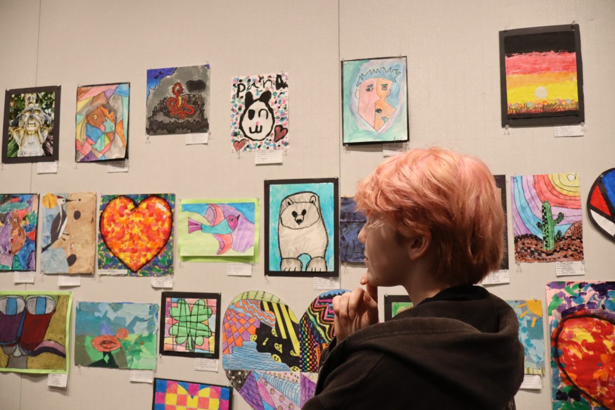 Rio Fernandez gases upon the many art pieces created by elementary schoolers. Featured in their own section, the district show is able to celebrate all ages artistic ability.