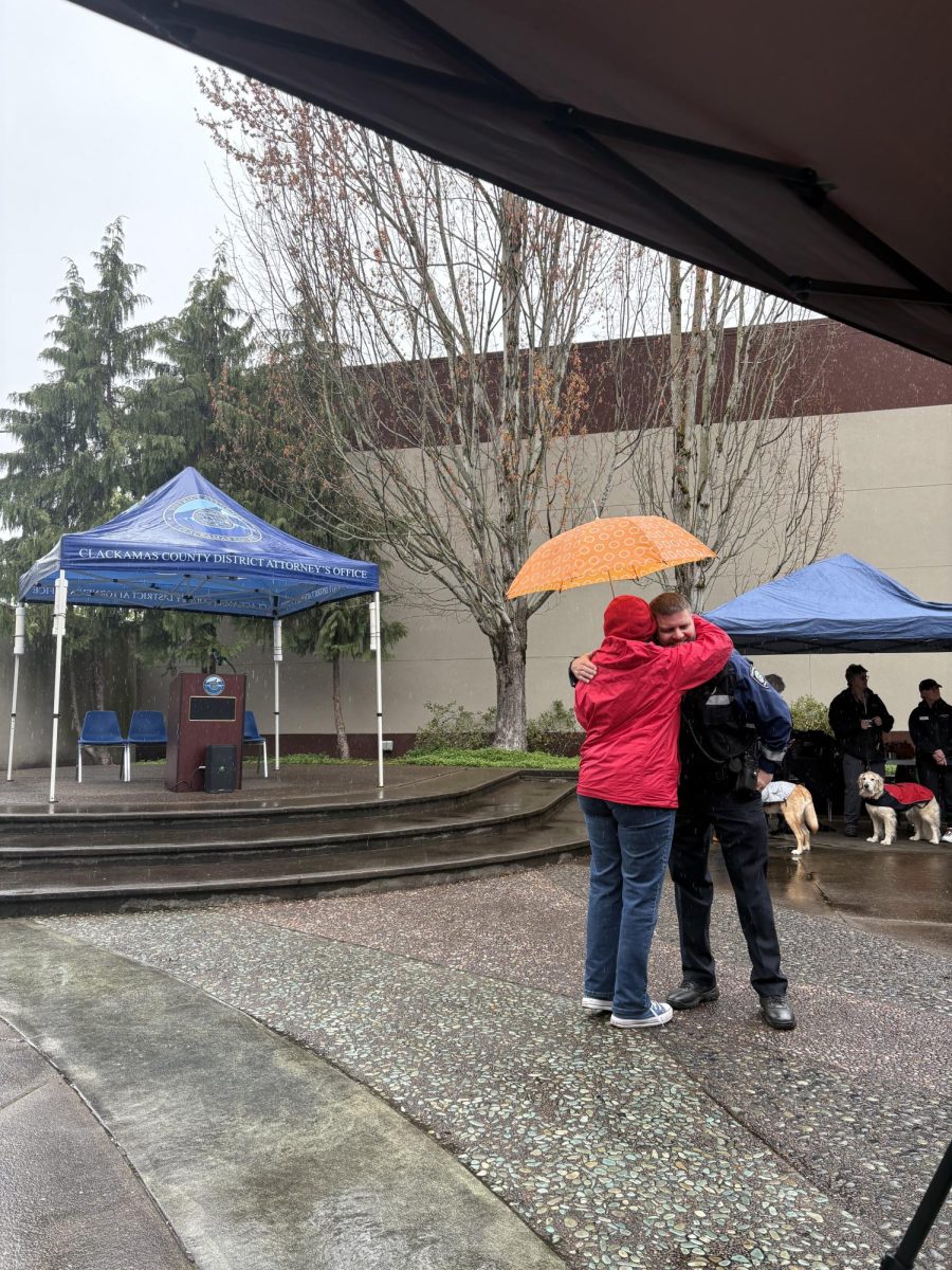 An image of Oregon City Mayor Denise McGriff hugging police chief Shawn Davis. There are all sorts of people involved in the criminal justice system and process.