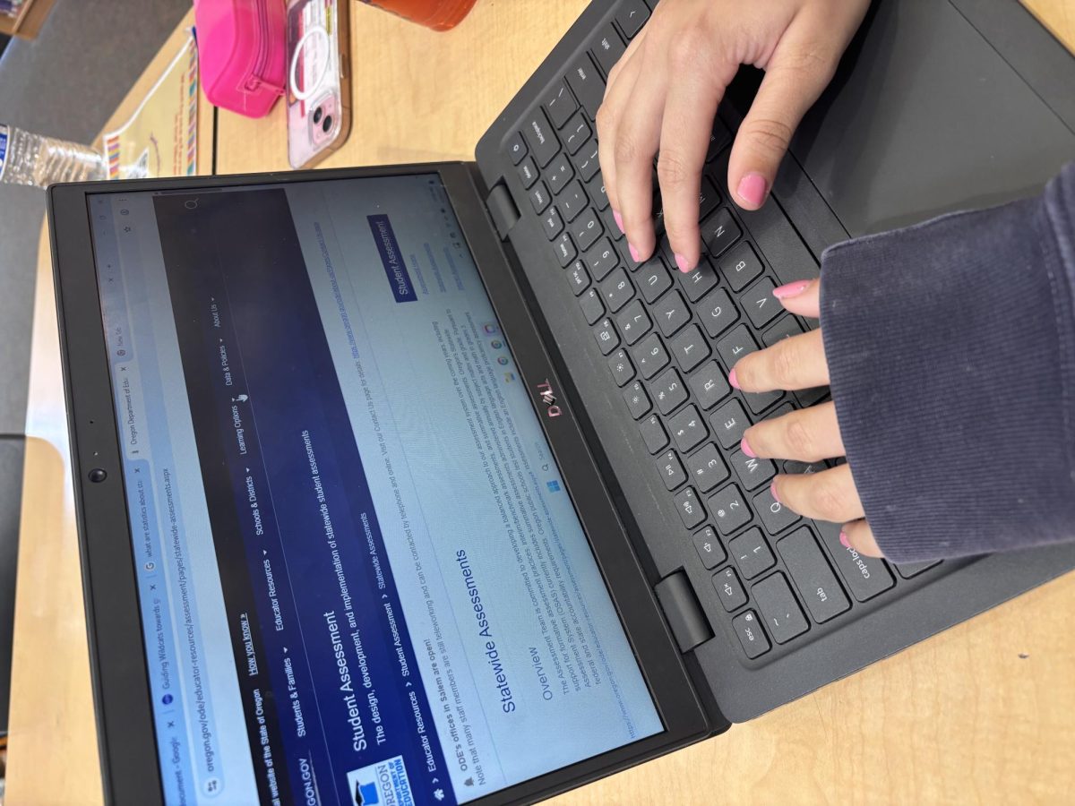 A student at Wilsonville Highschool examines the State Testing website. The front page is open to all the information surrounding the test.