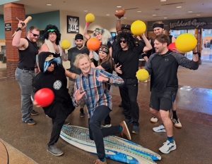 The teachers team gangs up on Mr. Ryan in their uniforms. The team didn’t only rule the dodgeball game but the outfits too.