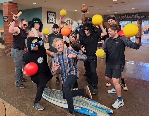 The teachers team gangs up on Mr. Ryan in their uniforms. The team didn’t only rule the dodgeball game but the outfits too.
