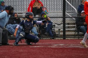 Sophomore Morgan Christiansen catching and framing a pitched ball by Addi Smith. Christiansen works hard behind the plate, and her effort helps to get valuable pitch calls. 
