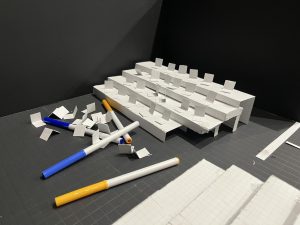 Theatre director Jason Katz creates a half-inch scale of the black box, a model of how riders for the space will be created. The room will need to be completely cleared out and deep cleaned, the bare space a ghost of its usual full capacity.