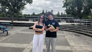 Sofia Lopez and Ryan Williams pose together outside the Wilsonville back doors. 