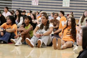 Freshmen clump together during an icebreaker challenge. Link Crew members scatter among the ninth graders to help everyone get involved and do their best to work together. 