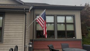 An American flag outside the Wilsonville Community Center. The flag is a symbol of patriotism, freedom, and opportunity. It represents the First Amendment, freedom of speech. Charlie Kirk died using his First Amendment rights, highlighting the fragility of open discourse and how political debate can turn violent. 