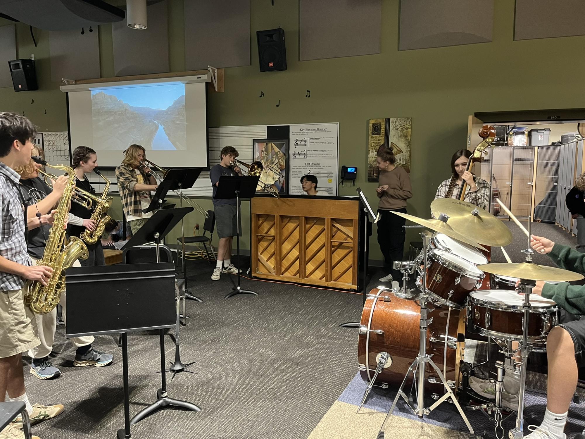 Jazz club members circle up and groove with one another, the combined effort of piano, drums, trumpet, cello, scatting, and more. Inspiration drawn from the riff of the day, but also the beat within their bodies.  