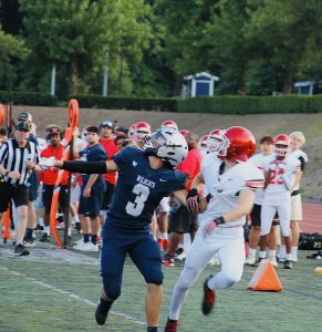 Senior Luke Carli goes up for a jump ball in their first of three games. The Jamboree is set up so each team gets twelve plays each game, with three total games played on the day.
