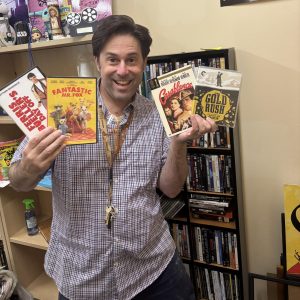 Theatre director Jason Katz poses with his precious physical media. He keeps the Blackbox relatively clean, but has a stash hidden away in his office.