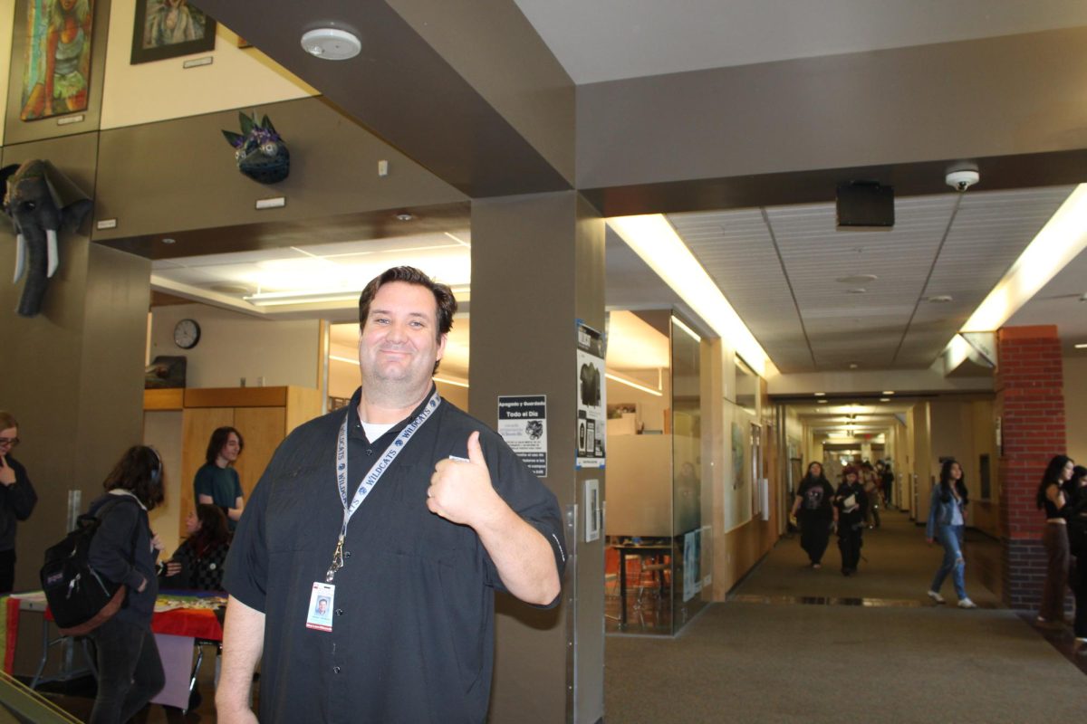 Mr. Jenkins smiles with a thumbs up while he views the new clubs in the 26' club fair. He shares, "Easily, the club that was the most impressive to me this year was the Jazz club. They gave a full concert, and I was blown away by each of the students' performances. I have been working in education for 18 years, and I've never heard a more competent jazz group. To have that as a club at the school shows not only the power of clubs at the school but also the importance of the Arts."