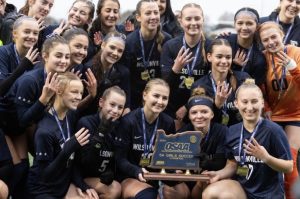 Wilsonville girls' soccer poses for a picture with their 4th state championship title. While their legacy is strong, this year's team works to play up to the reputation left by a bloodline of previous Wildcats. 