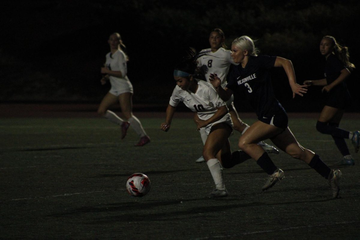 Senior starter, Camryn Schaan dribbles by a Tualatin player, pushing the ball forward. In the close match between the two teams, there was little time for mistakes, and the Cats had to take every chance they got to score. 