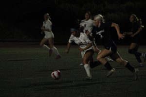 Senior starter, Camryn Schaan dribbles by a Tualatin player, pushing the ball forward. In the close match between the two teams, there was little time for mistakes, and the Cats had to take every chance they got to score. 