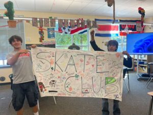 Isaiah Kessler and Pabel pose with their poster for the Skate Club, now in its second year. Judging by the amount of signatures, the club is swiftly becoming popular among many interested students.