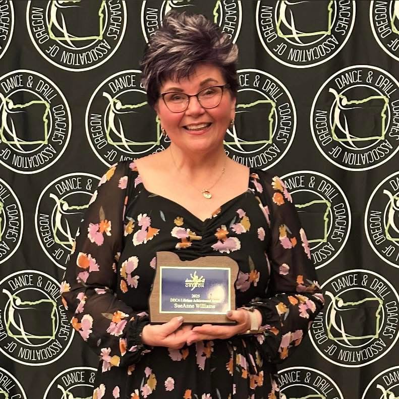 Assistant coach Sue Ann Williams receives an award from the Dance & Drill Coaches Association.   Williams has had a great impact on the Wilsonville High Schools cheer team in just two short years and she is a key component to the teams success. 