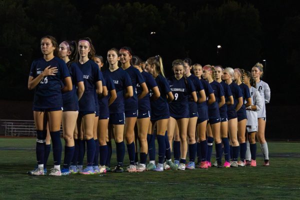 Wilsonville High School Girls soccer team is lined up for the national anthem before their game against Beaverton.
