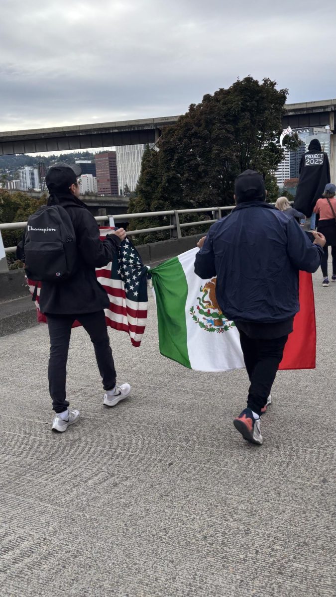 The two flags tied together represents the America and Mexican immigration, and how protesters feel that America should be working hand in hand with Mexican immigrants. This show of companionship was on Morrison Bridge in Portland.