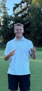 Charlie Nelson poses after 1st hole in one