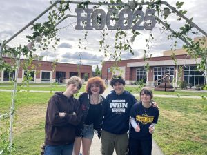 Left to right: Stevie Binns, Taylor Nichols, Ethan Spisak, and Aislinn Quinn finish the day off at Instafest. Posing underneath Grant Pass's HOCO decorations for their dance later that night. 