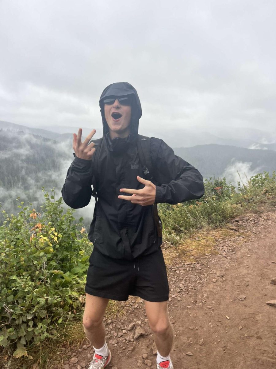 Julian Best celebrates his hike up the mountain.