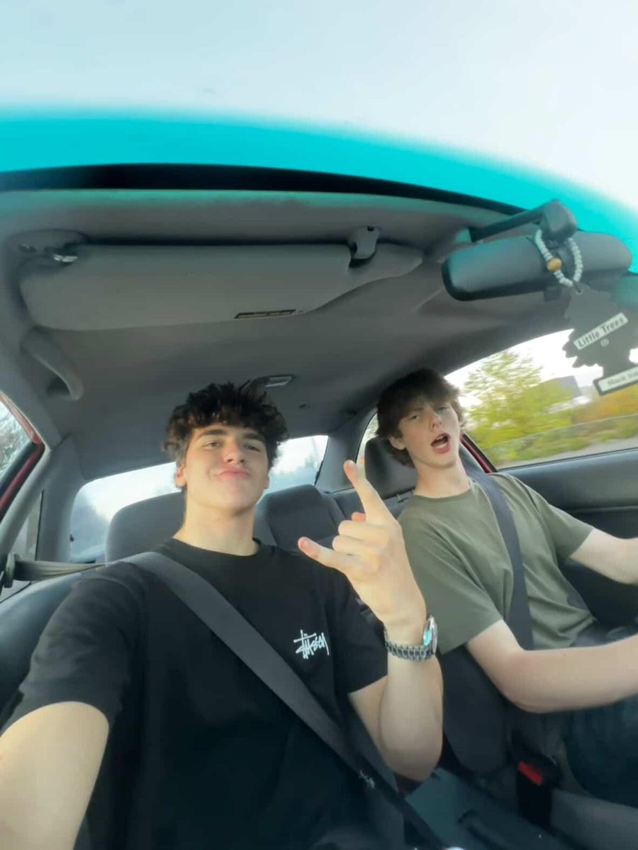 Landon takes a photo in the passenger seat with the driver. The driver is one of the people Landon associates with after school.

