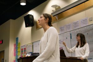 Choir Director, Karen Bohart (right), coaches Soul’d Out. She comes in every morning to teach the a cappella group and get them ready for competitions. Photo by Tyler Widener
