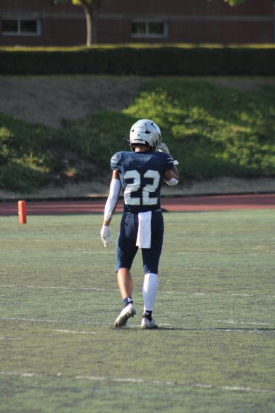 Wilsonville's wildcats sophomore, Emery Putnam walking out to the field getting ready to play defense. Putnam has been playing for the wildcats program for 5 years.