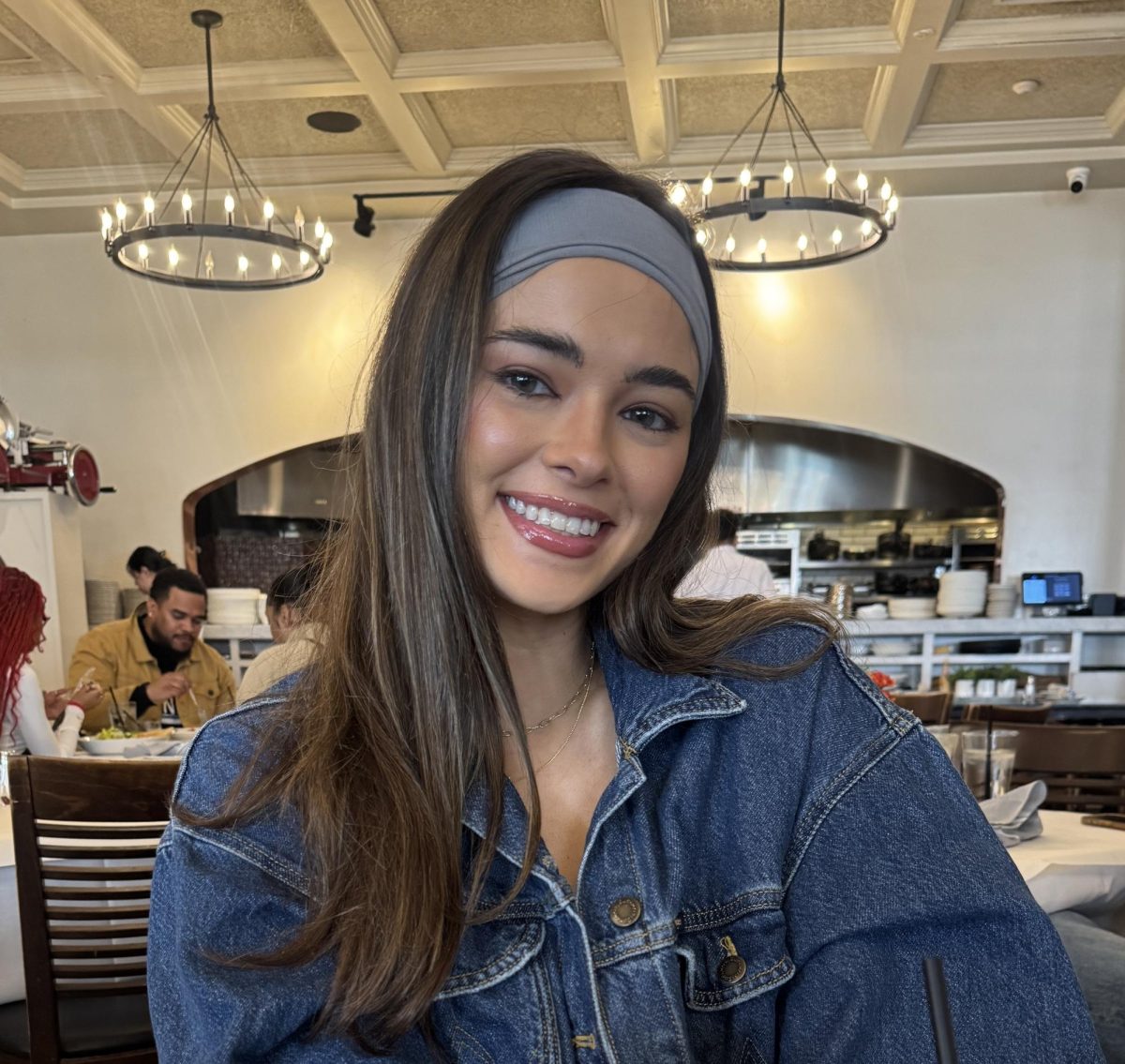 Emma Pattishall smiles in denim as she eats at her favorite brunch spot. Pattishall enjoys spending time with family and friends when not teaching.