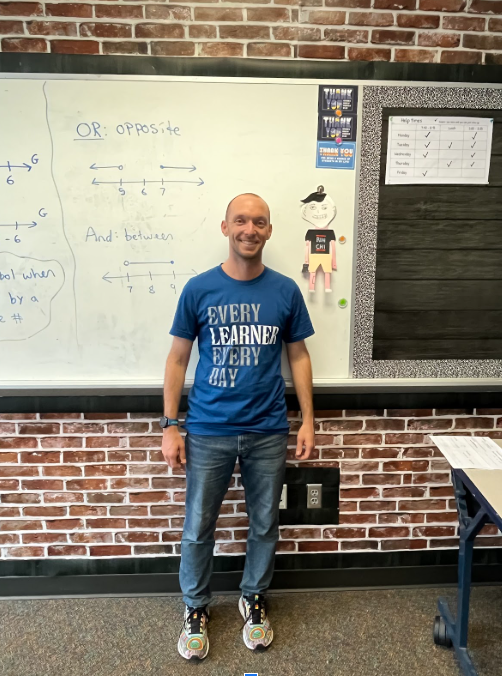 Brian Desalvo is a  math teacher at Wilsonville High School. In this photo he stands in front of his white board in his room.