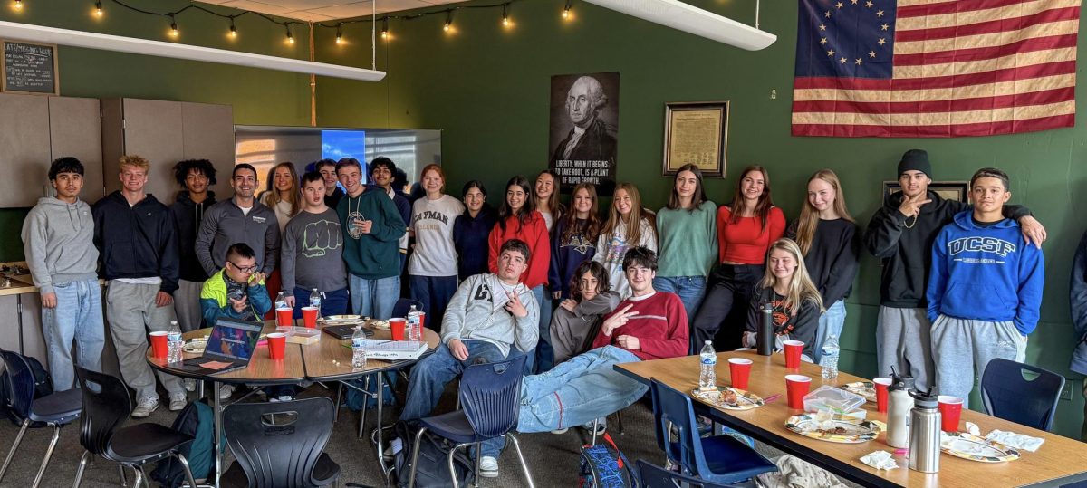 Mr. Esqueda's life class poses for a picture during their annual Thanksgiving meal. This final event marks just another ‘last’ for the class of 2026.