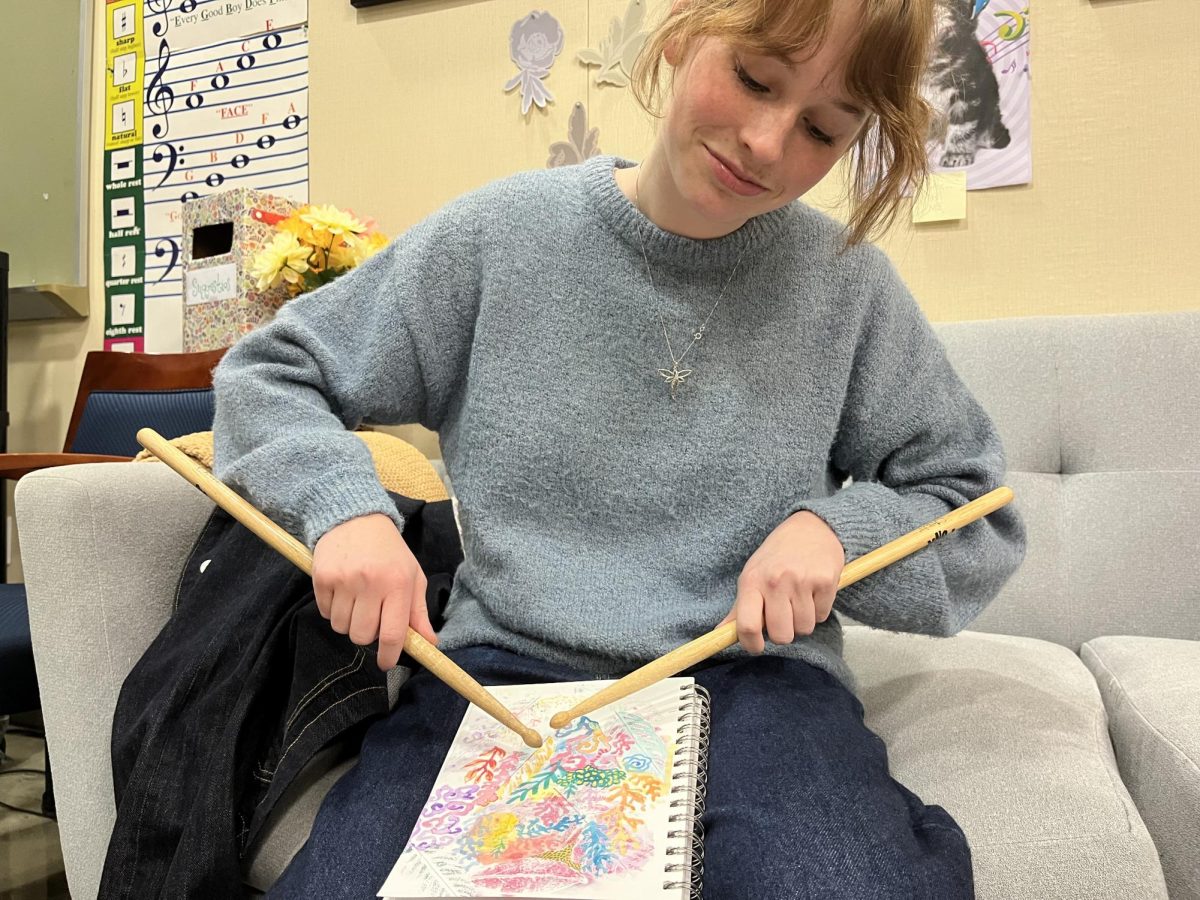 Mia Evans is hard at work on her art. Music combining with crayon as the design flourishes. 