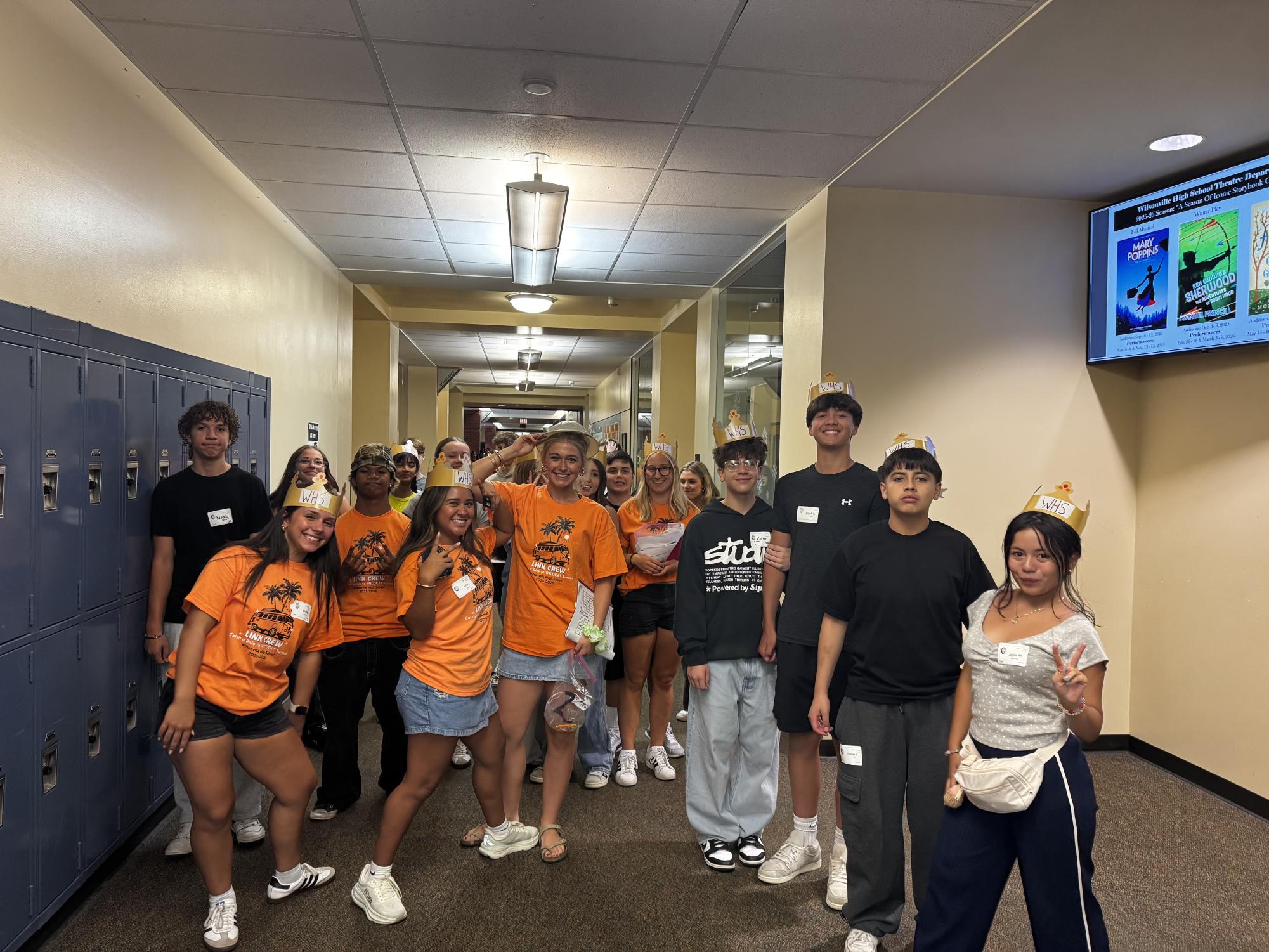 Link Crew members proudly wear their orange shirts as they tour incoming freshmen around the campus. Crowns lay upon each students' head; a craft they each group participated in during orientation. 