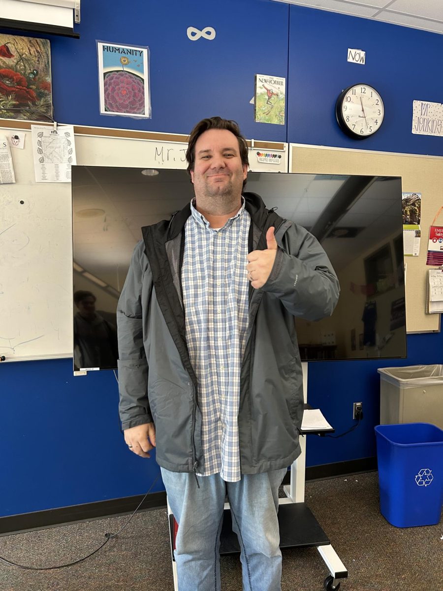 Mr. Jenkins poses with a thumbs up in his classroom. He started his career at Loyola Marymount University.