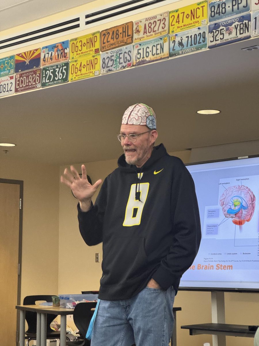 Psychology teacher, Mr. Van Deren, with his magnificent brain hat on. students craft their own model while he explains the instructions.