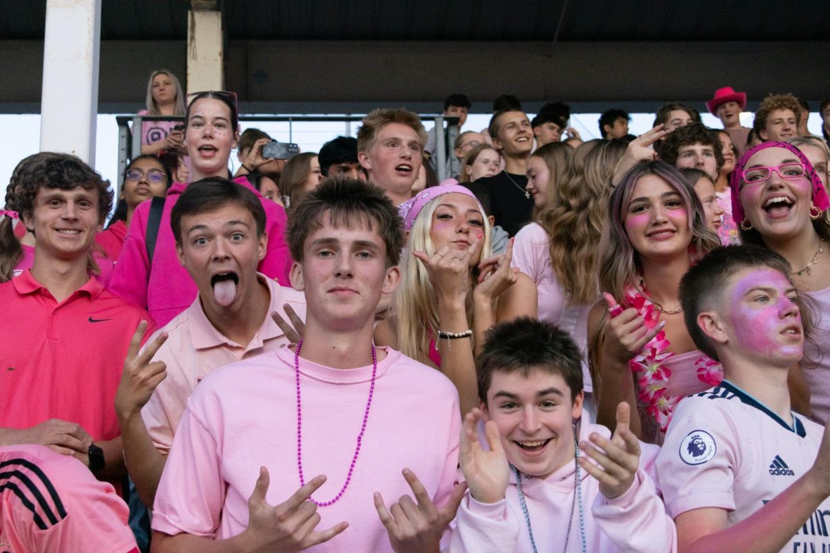 A full student section ready for our homecoming game to kickoff. A blanket of pink covers the home side to support.